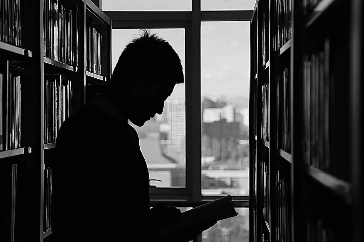 silhouette of man reading
