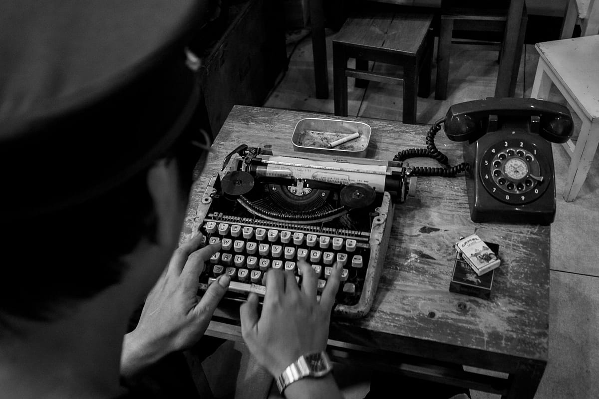analogue phone and typewriter on table