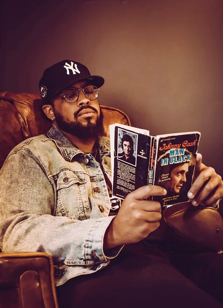 Cool black man reading in an armchair