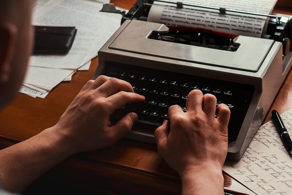 a person using black and gray typewriter